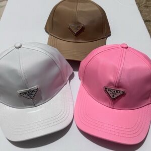 1x Prada Women's Pink, White, and Brown Hats